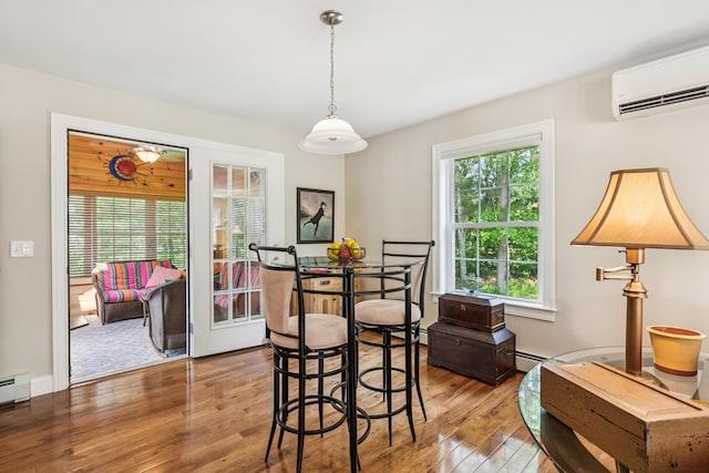 3 Bradfield Way, Kennebunk, ME 04043 - dining space featuring wood finished floors, an AC wall unit, and a baseboard radiator