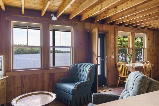 36 Cove Ln, Damariscotta, ME 04543 - living room featuring a water view, wood walls, wood finished floors, and wooden ceiling with exposed beams