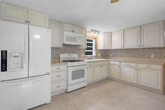 31 W Bay Bridge Rd, Topsham, ME 04086 - kitchen featuring white appliances, cream cabinets, decorative backsplash, light countertops, and a textured ceiling