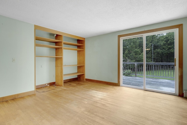 31 W Bay Bridge Rd, Topsham, ME 04086 - unfurnished bedroom with access to outside, light wood-type flooring, and a textured ceiling