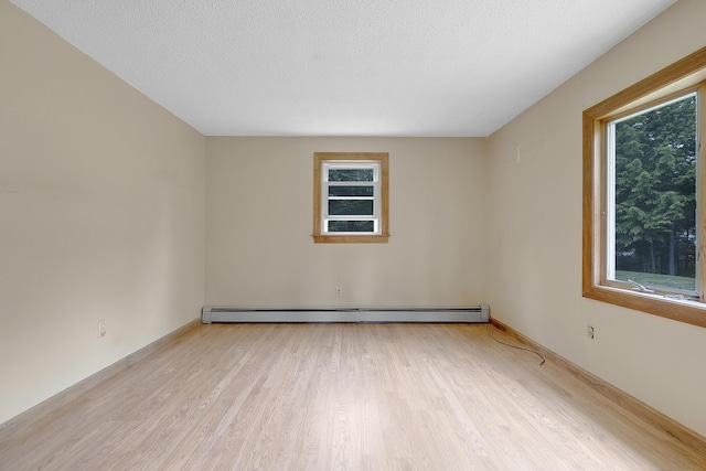 31 W Bay Bridge Rd, Topsham, ME 04086 - empty room featuring baseboard heating, healthy amount of natural light, and light wood-style floors