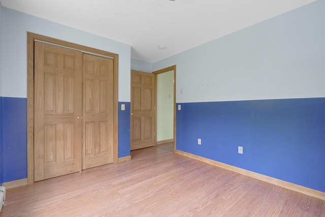 31 W Bay Bridge Rd, Topsham, ME 04086 - unfurnished bedroom featuring light wood finished floors, a closet, and baseboard heating