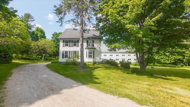 1835 Main St, Fayette, ME 04349 - view of front of house featuring a front yard, dirt driveway, and a garage