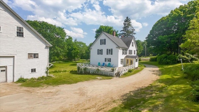 1835 Main St, Fayette, ME 04349 - view of home's exterior featuring a chimney, driveway, a deck, a yard, and view of wooded area
