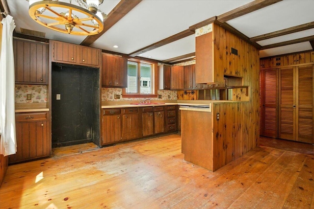 1835 Main St, Fayette, ME 04349 - kitchen with light countertops, beamed ceiling, light wood-style floors, and brown cabinets