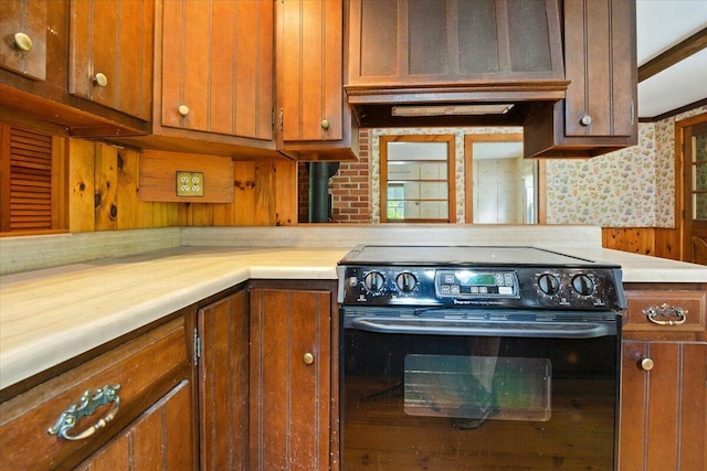 1835 Main St, Fayette, ME 04349 - kitchen with black electric range oven, light countertops, brown cabinetry, and ventilation hood