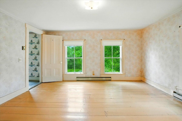 1835 Main St, Fayette, ME 04349 - unfurnished room with a baseboard radiator, hardwood / wood-style flooring, ornamental molding, and wallpapered walls