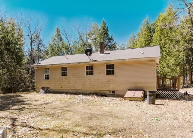 71 Darbick Ter, Hollis, ME 04042 - back of property featuring a chimney and a wooden deck