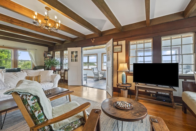 4 Hamlin Pl, York, ME 03909 - living area featuring beam ceiling, a chandelier, healthy amount of natural light, and wood finished floors