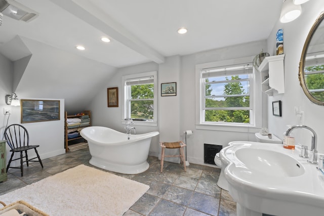4 Hamlin Pl, York, ME 03909 - bathroom featuring baseboards, stone tile flooring, a soaking tub, recessed lighting, and lofted ceiling