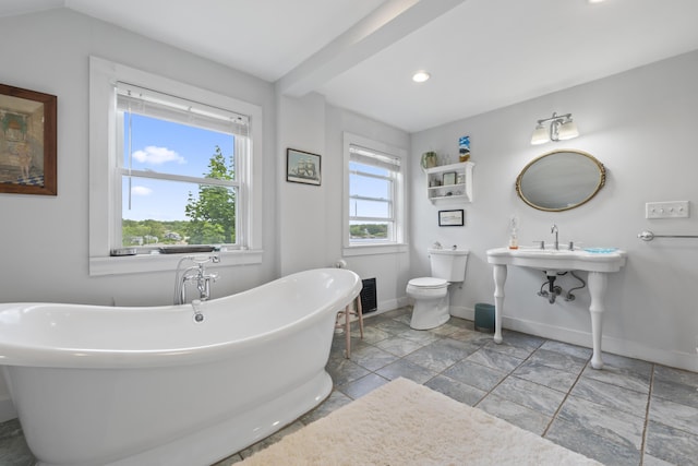 4 Hamlin Pl, York, ME 03909 - bathroom featuring a soaking tub, baseboards, toilet, recessed lighting, and stone finish floors