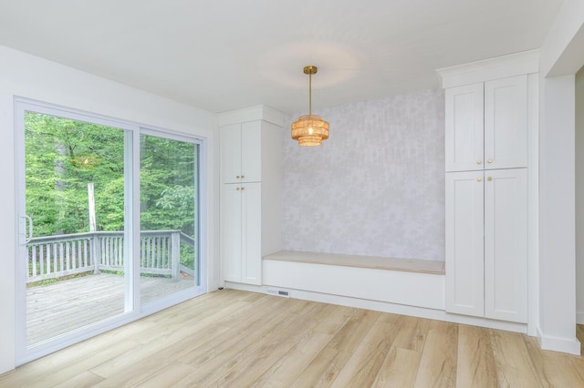 70 Whitten Rd, Kennebunk, ME 04043 - unfurnished dining area with light wood-type flooring and wallpapered walls