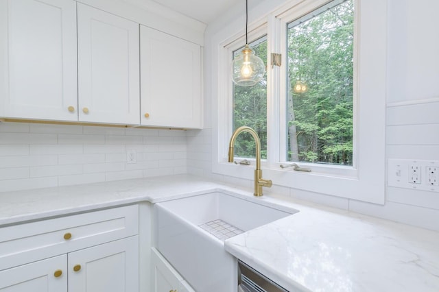 70 Whitten Rd, Kennebunk, ME 04043 - kitchen with white cabinetry, decorative backsplash, healthy amount of natural light, and light stone countertops