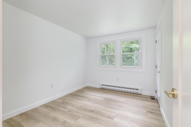 70 Whitten Rd, Kennebunk, ME 04043 - unfurnished room featuring a baseboard radiator and light wood-style flooring