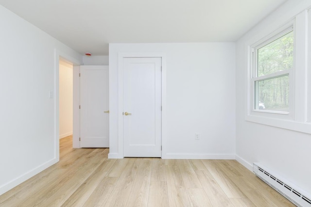 70 Whitten Rd, Kennebunk, ME 04043 - unfurnished bedroom featuring a baseboard radiator and light wood-type flooring
