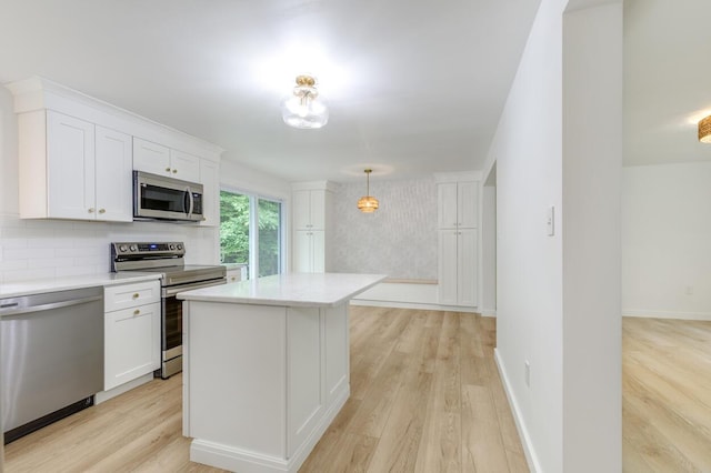 70 Whitten Rd, Kennebunk, ME 04043 - kitchen featuring appliances with stainless steel finishes, light countertops, white cabinetry, and light wood-style flooring
