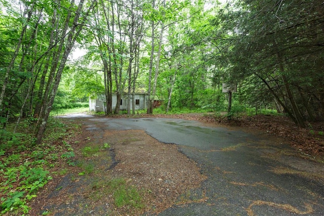 70 Whitten Rd, Kennebunk, ME 04043 - view of yard with an outbuilding, driveway, and a forest view