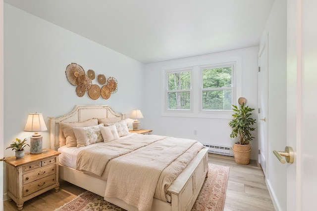 70 Whitten Rd, Kennebunk, ME 04043 - bedroom featuring light wood-style floors and a baseboard radiator