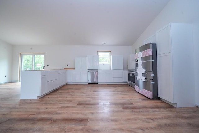 316 Clark Rd, Hermon, ME 04401 - kitchen with appliances with stainless steel finishes, lofted ceiling, healthy amount of natural light, light wood-style floors, and white cabinets