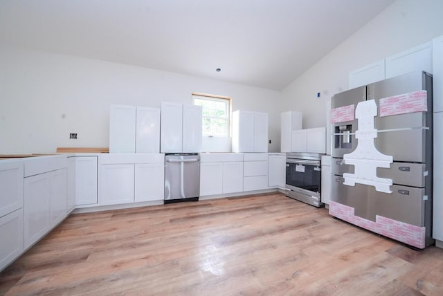 316 Clark Rd, Hermon, ME 04401 - kitchen featuring appliances with stainless steel finishes, light wood-style floors, white cabinetry, vaulted ceiling, and light countertops