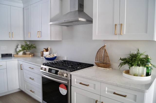 14 Salt Point Dr Unit 19, Old Orchard Beach, ME 04064 - kitchen with range hood, stainless steel range with gas cooktop, white cabinetry, and light stone countertops