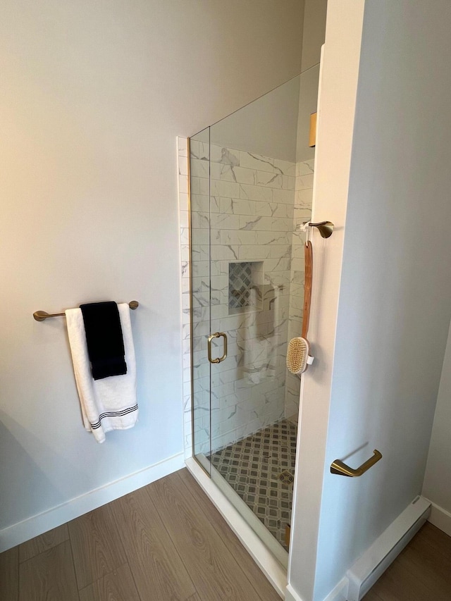 14 Salt Point Dr Unit 19, Old Orchard Beach, ME 04064 - bathroom featuring a stall shower, wood finished floors, and baseboards