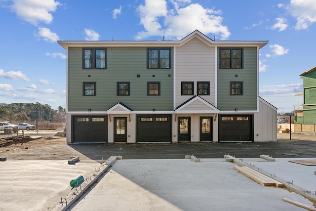14 Salt Point Dr Unit 19, Old Orchard Beach, ME 04064 - view of front facade featuring asphalt driveway, board and batten siding, and an attached garage