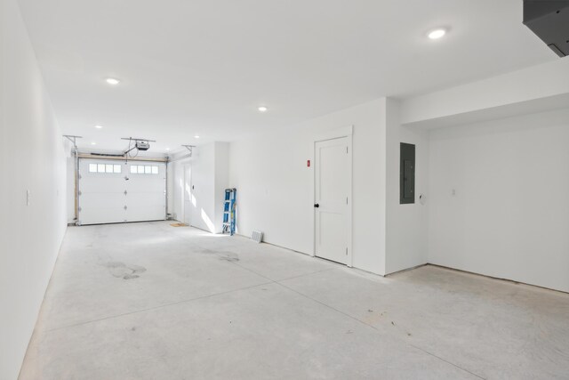 14 Salt Point Dr Unit 19, Old Orchard Beach, ME 04064 - garage with electric panel, a garage door opener, and recessed lighting