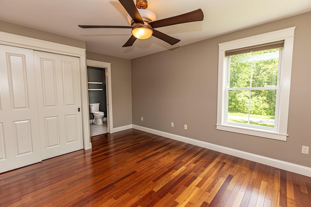33 Webb Rd, Windham, ME 04062 - unfurnished bedroom featuring dark wood-type flooring, multiple windows, ceiling fan, and a closet