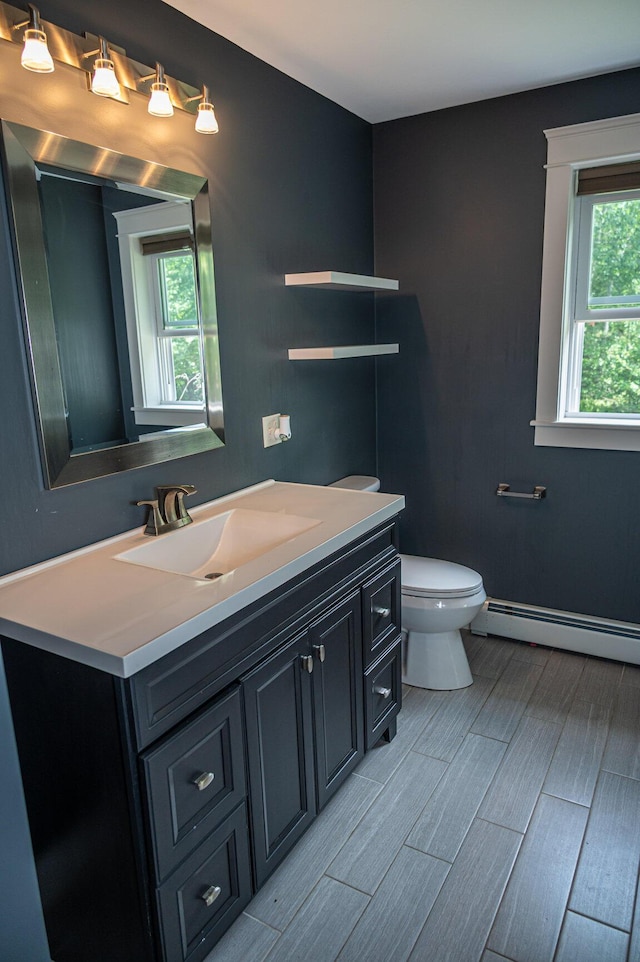 33 Webb Rd, Windham, ME 04062 - half bathroom featuring baseboard heating, vanity, and wood tiled floors