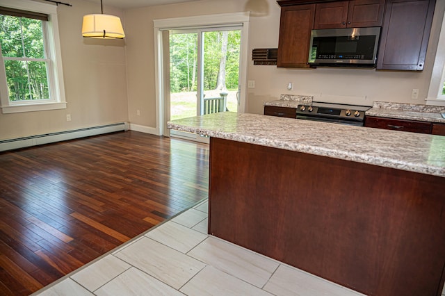 33 Webb Rd, Windham, ME 04062 - kitchen with stainless steel appliances, hardwood / wood-style floors, dark brown cabinets, decorative light fixtures, and light stone counters