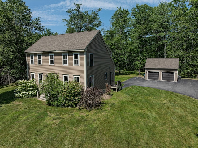 33 Webb Rd, Windham, ME 04062 - view of front of house featuring an outdoor structure, a shingled roof, a garage, and a front lawn