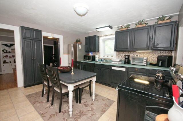 198 3rd St, Bangor, ME 04401 - kitchen with stainless steel appliances, light countertops, and light tile patterned flooring