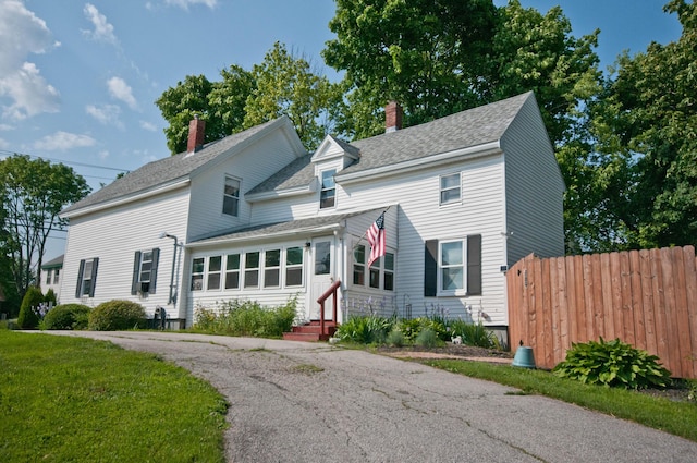 198 3rd St, Bangor, ME 04401 - traditional-style home with entry steps, a chimney, and roof with shingles