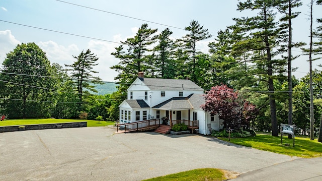 166 Franklin St, Bucksport, ME 04416 - traditional-style house with a front yard, a chimney, and a wooden deck