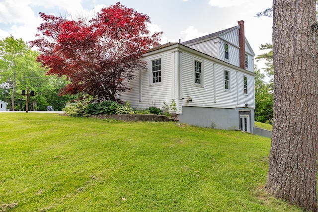 166 Franklin St, Bucksport, ME 04416 - view of property exterior featuring a chimney and a lawn