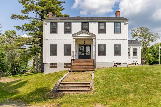 166 Franklin St, Bucksport, ME 04416 - view of front facade with a chimney, french doors, and a front yard