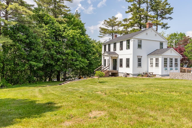 166 Franklin St, Bucksport, ME 04416 - back of property with a chimney, roof with shingles, and a yard