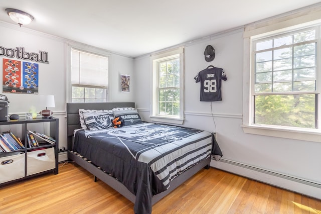 166 Franklin St, Bucksport, ME 04416 - bedroom with baseboard heating, hardwood / wood-style floors, and ornamental molding