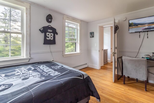 166 Franklin St, Bucksport, ME 04416 - bedroom with a baseboard radiator, light wood-style flooring, and crown molding