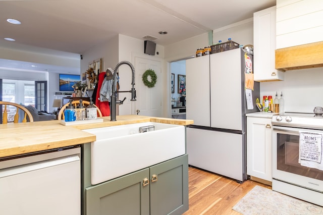 166 Franklin St, Bucksport, ME 04416 - kitchen with white appliances, green cabinets, light wood-style floors, butcher block countertops, and recessed lighting