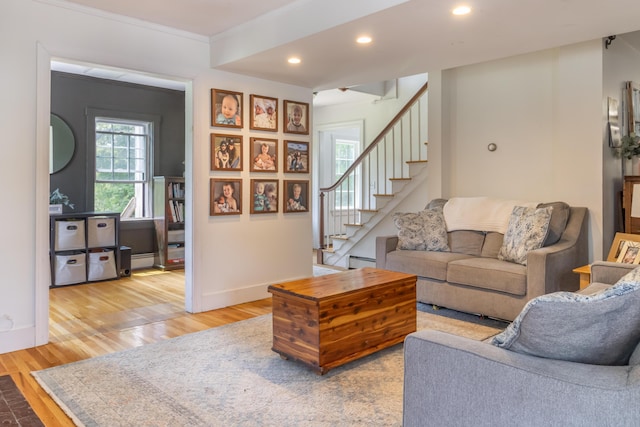 166 Franklin St, Bucksport, ME 04416 - living area with light wood finished floors, stairs, recessed lighting, a baseboard heating unit, and ornamental molding