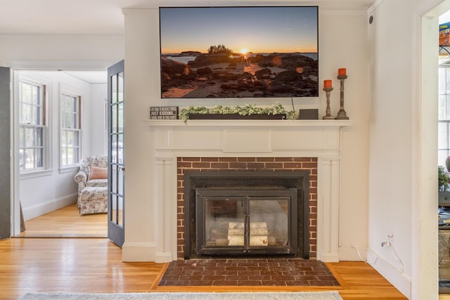166 Franklin St, Bucksport, ME 04416 - detailed view of a fireplace with flush hearth, wood finished floors, and ornamental molding