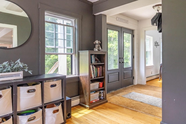 166 Franklin St, Bucksport, ME 04416 - foyer with a baseboard heating unit, wood finished floors, and plenty of natural light