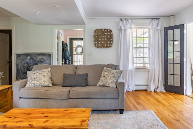 166 Franklin St, Bucksport, ME 04416 - living area with a baseboard heating unit and light wood-type flooring