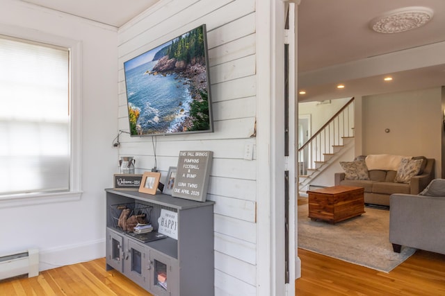 166 Franklin St, Bucksport, ME 04416 - corridor featuring a baseboard heating unit, stairs, wood finished floors, and recessed lighting
