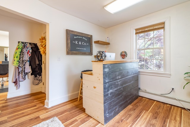 166 Franklin St, Bucksport, ME 04416 - detailed view of wood finished floors and a baseboard heating unit