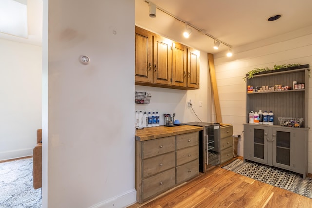 166 Franklin St, Bucksport, ME 04416 - bar with beverage cooler, rail lighting, and light wood-type flooring