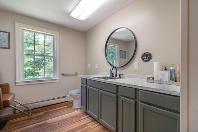 166 Franklin St, Bucksport, ME 04416 - bathroom with vanity, wood finished floors, and baseboard heating
