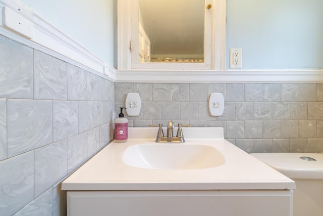 166 Franklin St, Bucksport, ME 04416 - bathroom with vanity, tile walls, and tasteful backsplash